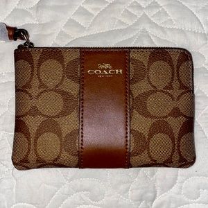 Brown Leather Coach Wristlet. Pockets for cards and zipper for coins inside.